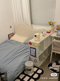 a bed room with a neatly made bed and desk