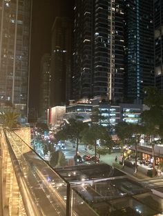 the city is lit up at night with skyscrapers in the background