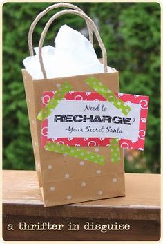 a brown paper bag with a red and white tag that says need to recharge your secret sale