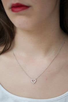 This minimalist necklace features a sterling silver heart.  The heart charm is meticulously adorned with brilliant clear cubic zirconia stones.A wonderful gift for that special someone to show them how long your love will last :)100% sterling silverThis lovely necklace will arrive in a organza bag, ready for gifting or to keep for yourselfThis simple necklace adds a special little something to your look!Perfect for everyday wear :)Shipped within 1-2 business days after cleared payment.Don't hesi Dainty Heart Pendant Diamond Necklace In Sterling Silver, Dainty Sterling Silver Heart Pendant Diamond Necklace, Cheap Silver Open Heart Necklace, Dainty Sterling Silver Diamond Necklace With Heart Pendant, Dainty Silver Diamond Heart Pendant Necklace, Sterling Silver Diamond Necklace With Heart Charm, Dainty Silver Diamond Heart Necklace, Dainty Heart Pendant Necklace In Cubic Zirconia, Sterling Silver Diamond Heart Necklace