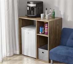 a blue chair sitting next to a small table with a coffee maker on top of it