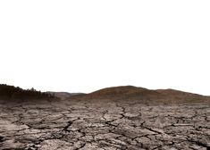 a barren landscape with mountains in the distance