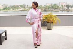 DESIGNER’S NOTE: This elegant pink kimono is crafted from pink lustrous satin paired with a printed floral pink satin that feels so smooth against your skin. We can't think of anything more luxurious to wear while you're getting ready on your wedding day. Designed to flatter your curves. Comfy chic. FIT: Slightly loose for a relaxed fit. Select your normal size ATTRIBUTES: Robe Length: 56 inches Model Stats: 5 ft 6, US 6 wearing a Medium size Color: Pink Fabric: Satin Print: Peacock design Sleev Feminine Wedding Robe With Kimono Sleeves, Wedding Robe With Kimono Sleeves For Spring, Spring Wedding Robe With Kimono Sleeves, Pink Kimono For Spring Wedding, Feminine Pink Satin Gown, Spring Wedding Pink Kimono, Elegant Pink Wedding Robe, Elegant Pink Kimono For Loungewear, Pink Silk Kimono For Wedding