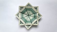 an origami clock made out of one dollar bill