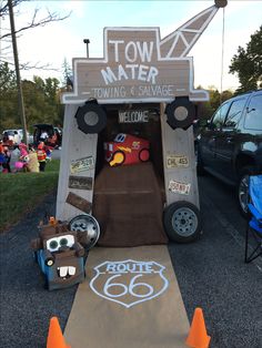 the entrance to town water is made out of cardboard and decorated with cars, trucks, and signs