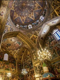 an ornately decorated church with chandeliers and paintings