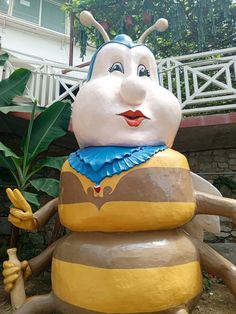 a large statue of a bee holding a banana