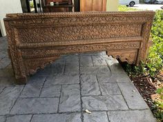 an old wooden bench sitting on top of a sidewalk