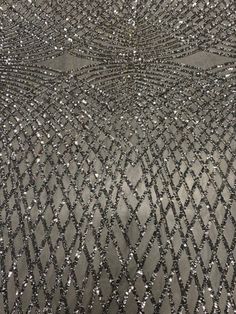 an abstract pattern made up of silver sequins