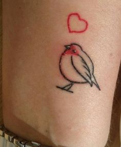 a small bird with a heart tattoo on its arm