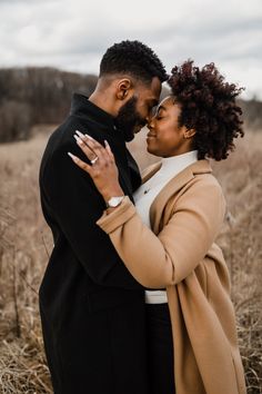 a man and woman embracing each other in a field