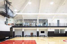 an indoor basketball court with benches and equipment