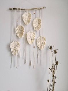 a white wall hanging with some flowers on it