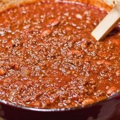 a pot filled with chili and beans on top of a stove