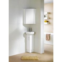 a bathroom with a sink, mirror and towel rack on the wall next to it