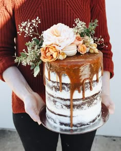 a person holding a cake with flowers on it and an instagram post about wedding cakes