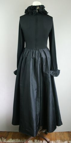 "This is a beautiful and timeless gown by designer Victor Joris (His bio is very interesting and accomplished). This garment features a dramatic ruffled neckline embellished with a white magnolia (a nod to his Louisiana roots) and ruffled cuffs. It is fully lined and impeccably constructed. Estimated size M/L 38\" bust 28\" waist full hip 40\" waist to hem (with 3\" hem) Purveyor's Note: We have searched far and wide, wrestled bears, braved the cold, traversed mountain ranges, fought pirates, sw Historical Ball Gown Dresses For Formal Occasions, Historical Formal Ball Gown Dresses, Formal Vintage Dress With Historical Design And Fitted Style, Historical Fitted Formal Dresses, Fitted Full Skirt Victorian Dress In Vintage Style, Fitted Vintage Victorian Dress With Full Skirt, Fitted Full Skirt Vintage Victorian Dress, Classic Formal Victorian Dress With Historical Design, Classic Victorian Dress For Formal Occasions