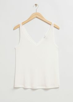 Loose-fit v-neck tank top crafted from soft, silky jersey fabric. Designed with a deep v-cut front and back neckline in a loose fit silhouette. Length of top: 39cm / 15.4" (EU 36 / UK 8 / US 4) Top Crafts, V Neck Tank Top, V Cut, V Cuts, Fashion Story, White Tank Top, Vest Top, Vintage Jeans, Feminine Style