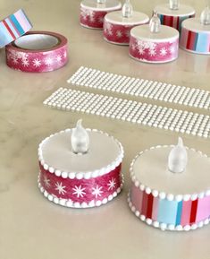 there are several decorated cakes on the table with ribbons and tape around them, including one for each cake