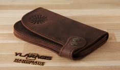 100 % full-grain handmade leather wallet of a unique design. Dark brown wallet. Precisely made from high quality cow leather. Lasts for years, therefore is a perfect gift. The wallet is engraved with an ancient stylized sun sign. Wallets are made from full grain cow leather. Crazy horse is a specially processed leather type that gives it an antique appearance. This type of leather is long lasting, very durable and any scratches or rubs turn it to a different shade, bend line also fades to a diff Leather Wallet With Leather Lining As Gift, Handmade Leather Wallets As Gifts, Handmade Leather Wallets For Gifts, Stylized Sun, Saddle Bag Purse, Handmade Gifts For Men, Leather Phone Wallet, Engraved Wallet, Leather Laptop Backpack