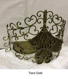 a tiara that is sitting on top of a white tablecloth with an ornate design