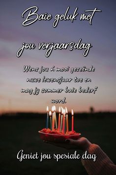 someone holding a birthday cake with lit candles on it and the words, bake gluk net you vegagarsday