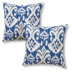 two blue and white pillows sitting next to each other