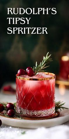 a red drink with cranberries and rosemary garnish on the rim, sitting on a white plate