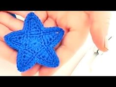 a crocheted blue star in someone's hand