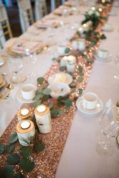 the table is set with candles and place settings