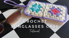 a crochet sunglasses case sitting on top of a checkered table