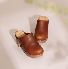 Luxury Brown Clogs With Cushioned Footbed, Luxury Brown Suede Clogs, Luxury Leather Clogs For Fall, Luxury Classic Calf Leather Clogs, Luxury Brown Leather Clogs, Comfortable Brown Clogs With Rubber Sole, Comfortable Leather Clogs With Wooden Heel, Comfortable Open-heel Clogs With Wooden Heel, Comfortable Brown Clogs With Cushioned Footbed