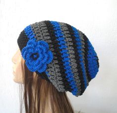 a crocheted hat with a flower on the top is shown in front of a mannequin's head