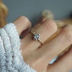 a woman's hand with a diamond ring on it