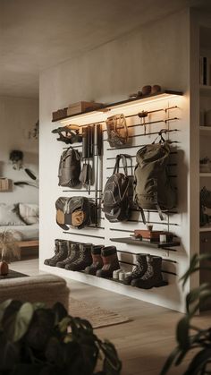 A minimalist room with a sleek camping gear wall, organizing outdoor adventure gear in a clean, simple way. Hiking Gear Storage Ideas, Gear Wall Storage, Outdoor Gear Room, Ski Storage Ideas, Climbing Gear Organization, Sports Gear Storage