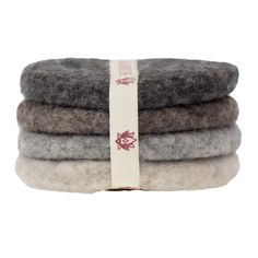 three pieces of grey and white wool sitting on top of each other