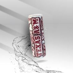 a close up of an energy drink with water splashing around it