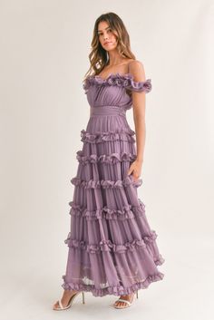 Romantic frills enliven this tiered maxi dress done in a flow-y fabric and trimmed in cascading ruffles. • Adjustable Straps• Ruffled Off Shoulder Neck line• Belted Tie Back Waist• Tiered Ruffle Details• Lined• Back Zipper• Approximately 42" length from waist down Long Ruffle Dress, Purple Ruffle Dress, Lilac Bridesmaid Dresses, Purple Bridesmaids, Flowy Mini Dress, Cascading Ruffles, Ruffle Trim Dress, Tiered Ruffle Dress, Frill Dress