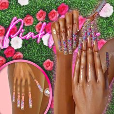 a woman's hands with pink and white nail polish on them, next to flowers