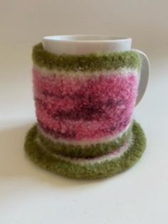 there is a cup that has been made out of yarn