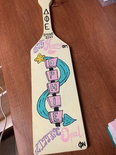 a wooden paddle with the word hope painted on it