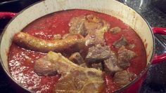 meat and tomato sauce in a pot on the stove