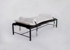 a black and white bench with tassels on it