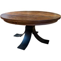 a round wooden table with metal legs and a black base on an isolated white background