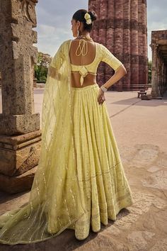 Yellow attached cancan lehenga with all over bahara bloom chikankari embroidery using sequin, cutdana embellishments in paisley bloom pattern. Paired with an elbow sleeves sequin-cutdana chikankari padded blouse and an organza gota striped, sequin embellished dupatta. - Aza Fashions Yellow Choli With Chikankari Embroidery, Yellow Georgette Choli With Chikankari Embroidery, Fitted Anarkali Choli With Chikankari Embroidery, Festive Yellow Choli With Chikankari Embroidery, Yellow Chikankari Embroidered Floor-length Lehenga, Fitted Georgette Lehenga With Motifs, Fitted Bollywood Lehenga With Chikankari Embroidery, Transitional Bollywood Lehenga With Chikankari Embroidery, Traditional Yellow Lehenga With Chikankari Embroidery