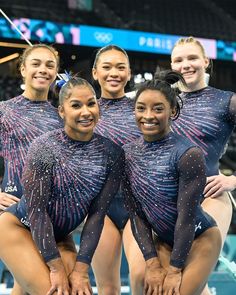 four female gymnastics team posing for a photo