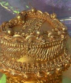 a cake with gold decorations on top of it