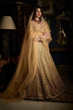 Gold Beaded Embellished Bridal Indian Lehenga set includes weighty gold weaving in a straight example. The full-sleeved pullover has a plunging neck area. The lehenga set shows sensitive pearl, gold beaded detail at the neck area, abdomen, and wrist. It is matched with a completely embellished dupatta.
For more details contact us on our WhatsApp 
+1 (732) 351-5426
Visit our website 
www.nameerabridal.com
#bridaldressonline #bridaloutfit #usabridalgown #usabridaldress #onlinebridaldress #pakistan Beaded Lehenga, Golden Bridal Lehenga, Scalloped Dupatta, Full Sleeves Blouse, Gold Sequin Jacket, Pearl Mirror, Polygon Pattern, Sequin Lehenga, Jacket Lehenga