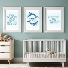 a baby's room with two pictures on the wall and a crib next to it