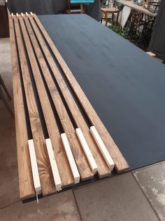 several pieces of wood sitting on top of a black tablecloth in a warehouse area